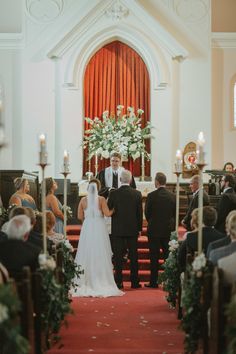 the bride and groom are standing at the alter