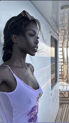 a woman standing on the deck of a boat