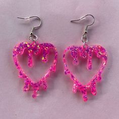 these lightweight drippy heart earrings are made with a vibrant pink glitter that has reflects of orange, blue and green - other colours available Pink Heart Resin Earrings, Pink Resin Heart Earrings, Pink Glitter Heart Earrings For Party, Goofy Earrings, Drippy Heart, Glitter Jewelry, Resin Crafts Tutorial, Diy Earrings Polymer Clay, Pink Jewelry