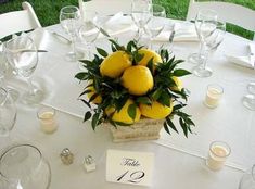 the table is set with lemons and candles