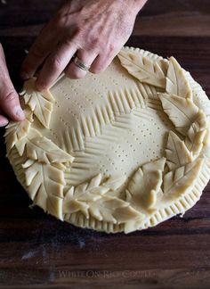 a person is making a pie crust in the shape of a star with leaves on it