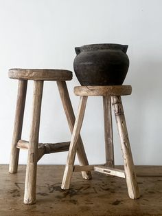 two wooden stools sitting next to each other