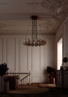 an empty room with white walls and chandelier