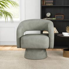 a living room with a chair and book shelf