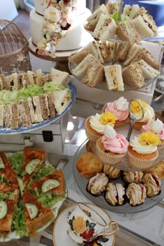 a table topped with lots of different types of cakes and pastries next to each other