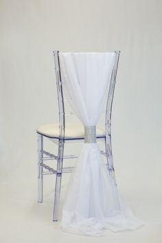 a chair with a white cloth draped over it and two chairs sitting next to each other