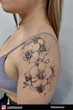 a woman with a flower tattoo on her shoulder