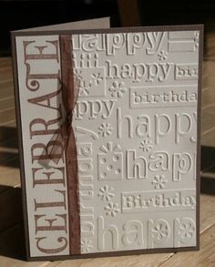 a birthday card with the words happy birthday written in white and brown on it, sitting on a wooden table