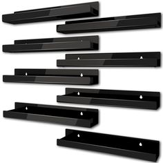 several black shelves are arranged in the shape of horizontals and rectangles with holes on them