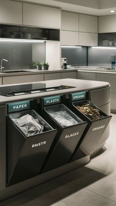 three trash cans in the middle of a kitchen