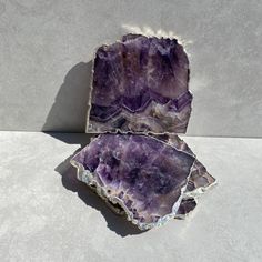 two ametholite pieces sitting on top of each other