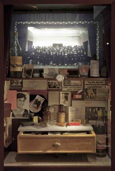 a display case filled with lots of bottles and papers