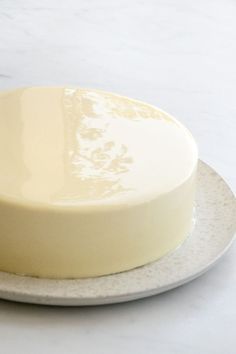 a white cake sitting on top of a plate