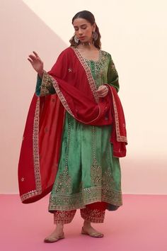 Green choga featuring floral embroidery with rose gold kasab and tilla work. Paired with red salwar and an embroidered dupatta., Fit: Relaxed Red Palazzo Pants, Velvet Kurta, Vintage Rose Gold, Indian Wedding Wear, Silk Dupatta, U Neck, Indian Fashion Designers, Silk Organza, Fashion App