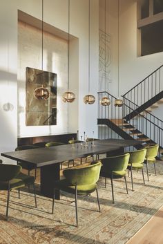 a dining room table with chairs and a chandelier hanging from the ceiling above it