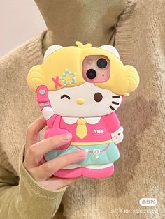 a person holding a cell phone case with a hello kitty design on the front and back