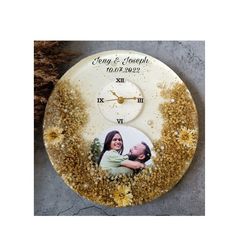 a clock with an image of a man and woman on the face is covered in gold flakes