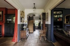 the hallway is decorated in black, red and white with lots of bookshelves