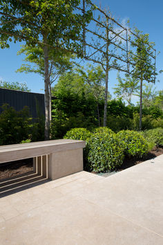 Dijon Brushed limestone tiles laid in a garden surrounded by foliage and greenery. Paving Ideas, Stone Paving, Outdoor Paving, Paver Tiles