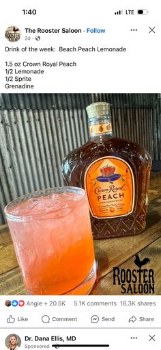 a bottle of booze sitting next to a glass filled with liquid on top of a wooden table