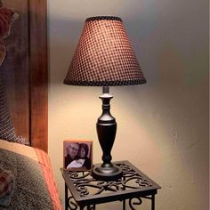 a lamp on a night stand next to a teddy bear