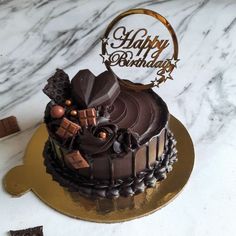 a birthday cake with chocolate frosting and decorations