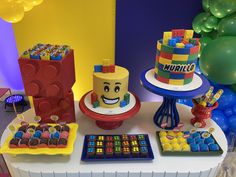 a lego themed birthday party with cake, candy and decorations