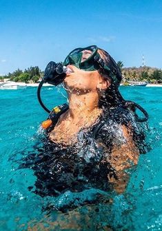 a man swimming in the ocean wearing a mask and goggles