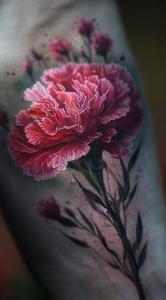 a pink flower tattoo on the side of a woman's leg with watercolors