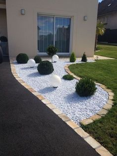 a house with landscaping in front of it and grass on the side walk to the door