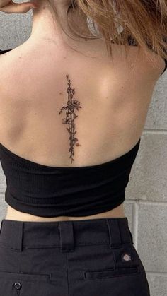 a woman with a cross tattoo on her back