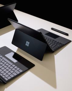 two laptops and a keyboard on a table