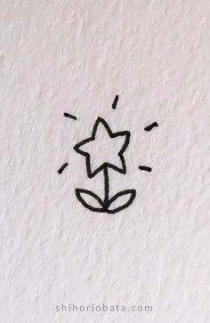 a drawing of a star on the side of a white wall with black ink in it