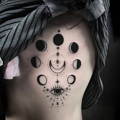 a woman's face with phases and stars on her back shoulder, as well as an all seeing eye tattoo