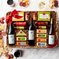 an assortment of wine, cheese and crackers on a tray