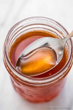 a spoon in a jar filled with liquid