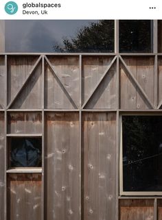 the side of a wooden building with multiple windows