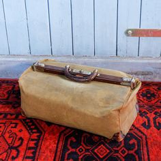 an old suitcase sitting on top of a rug