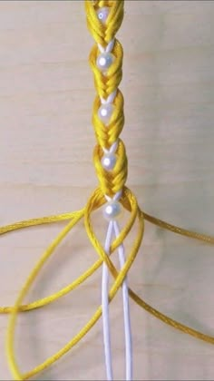 a close up of a yellow and white string