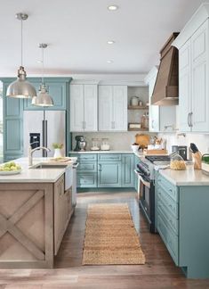 a kitchen with blue cabinets and an island in front of the counter top is shown