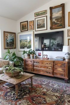 a living room filled with furniture and pictures on the wall above it's coffee table