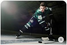 an image of a hockey player on the ice in uniform and ready to kick the puck