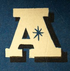 the letter a is made out of black and white paper with an arrow on it