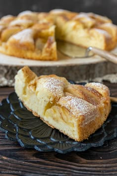 a slice of apple pie on a black plate