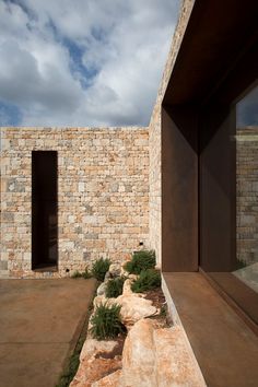 an exterior view of a house with stone walls