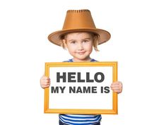 a little boy holding up a sign that says hello my name is on it and wearing a hat