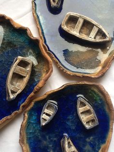 three decorative plates with boats on them