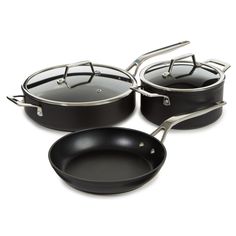 three black pots and pans on a white background