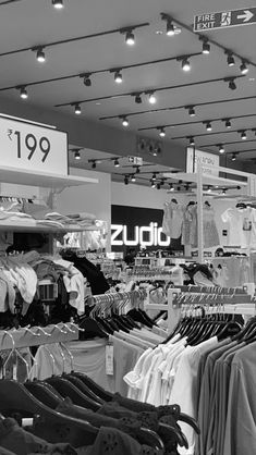 there is a clothing store with clothes on display in black and white colors