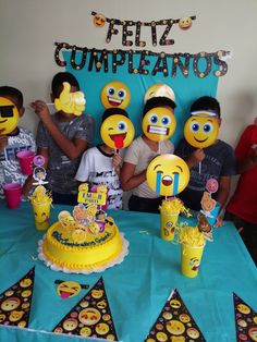 a group of people that are standing in front of a table with some cake and decorations